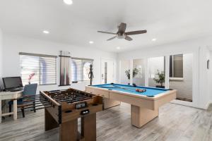 a living room with a pool table and a ceiling fan at Premier Host Villa-Heated Pool, Golf, Mayo Clinic in Phoenix