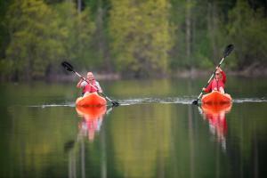 two people are in kayaks on a lake at Sun Mountain Lodge in Winthrop +74 photos