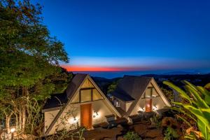 a house with a view of the sunset at SaffronStays Hillside Harriers, Lonavala - A Frame chalets with bathtub for couples in Lonavala