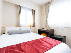 Postel nebo postele na pokoji v ubytování Kyoto inn Mio