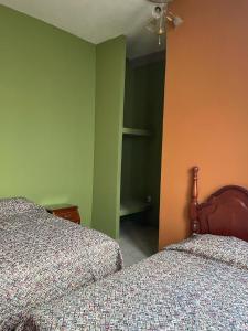 Postel nebo postele na pokoji v ubytování HOTEL PUEBLO GRANDE