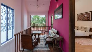 a living room with a pink wall at The Bohome in Quy Nhon
