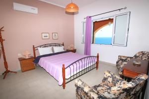 A bed or beds in a room at Villa Takis on Pelekas beach Apartment B with sea view