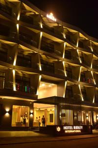 a night view of a hotel building with lights at Hotel Ridley International in Digha
