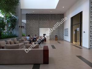 a lobby of a building with people sitting on couches at DanZaStay@BellSuite in Sepang