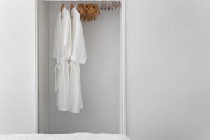 a closet with white clothes hanging in it at HideAway on Tallean in Nelson Bay