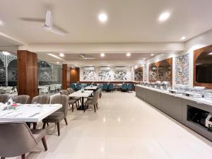 a dining room with tables and chairs and a counter at Olive Resort - Sillari Pench in Silāri
