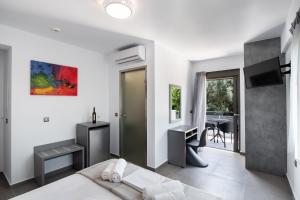 a bedroom with a bed and a desk and a television at Aurelia in Nikiana