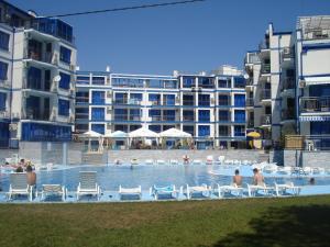 a large swimming pool with people in a hotel at Blue Bay Palace Apart Complex in Pomorie