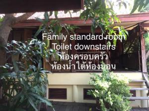 a sign on the side of a house with plants at Luang Chumni Village in Phra Nakhon Si Ayutthaya