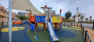 a playground with a slide in a park at First Line of The Beach La Garita in La Garita