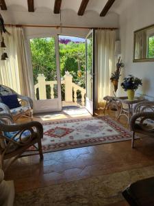 a living room with an open door to a patio at maison nathalia in Jávea