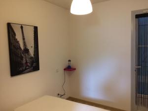 a room with a picture of the eiffel tower on the wall at appartement T3 in Aureilhan