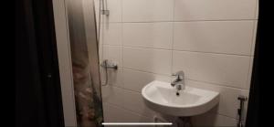 a white bathroom with a sink and a shower at Delta 8 - two big beds in Tartu