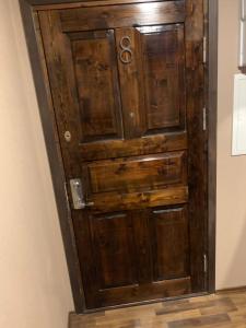an old wooden door in a corner of a room at Delta 8 - two big beds in Tartu