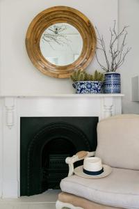 a mirror over a fireplace with blue and white vases at Boutique Guesthouse Hanover in Hanover