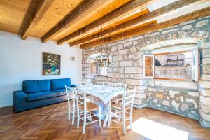 comedor con mesa y sofá azul en Apartments Martecchini, en Dubrovnik