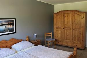 グレーミッツにある"Pappelhof - Whg 2"のベッドルーム1室(ベッド2台、木製キャビネット付)