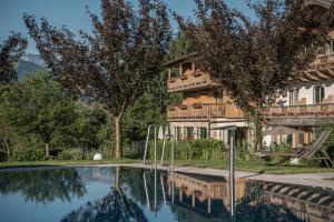 a resort with a swimming pool in front of a building at Bachmanngut in St. Wolfgang