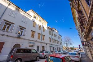 a group of cars parked on a city street at Apartman Anja in Rijeka