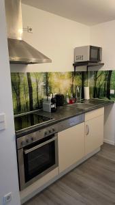 a kitchen with a sink and a stove top oven at Schicht am Bach in Essen