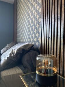 a glass table with a candle on top of it next to a bed at LOFT DIONYSIEN DE STANDING in Saint-Denis