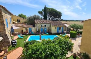an external view of a villa with a swimming pool at Logis Hôtel La Bastide Saint Bach in Suze-la-Rousse