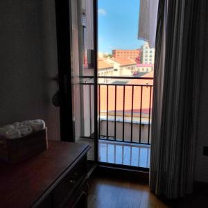 a view of a balcony from a room with a window at Chiqui Home in Salamanca