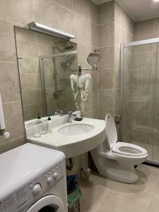 a bathroom with a sink and a toilet and a shower at Bakuriani Crystal Resort in Bakuriani