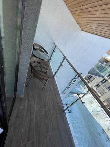a chair sitting under a glass table in a room at Bakuriani Crystal Resort in Bakuriani +2 photos