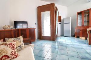 a living room with a couch and a refrigerator at Leuca lungomare by LoveSud in Leuca