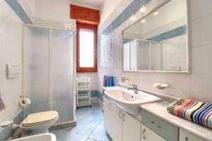 a bathroom with a sink and a toilet and a mirror at Leuca lungomare by LoveSud in Leuca +44 photos