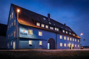 a blue building with the wordrosis on the side of it at ApartHotel Rose in Ellwangen