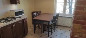 a small kitchen with a table and a microwave at Ogarna 88 in Gdańsk +26 photos