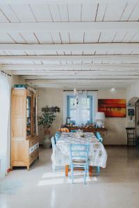 a dining room with a table and blue chairs at Casa Aquarela in Cogorno