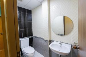ein Badezimmer mit einem WC, einem Waschbecken und einem Spiegel in der Unterkunft Restiny Hostel in Bangkok