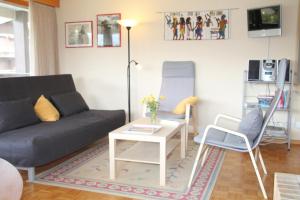 a living room with a couch and a table and chairs at Scierie A Meya 118 in Vercorin