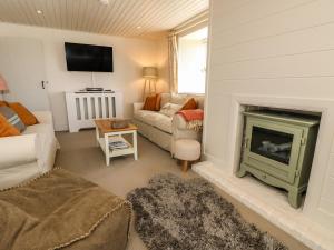 a living room with a couch and a fireplace at Compton Grange in Newport