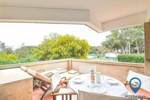 eine Terrasse mit einem Tisch und Stühlen auf dem Balkon in der Unterkunft Balaia Beach T2 com piscina in Albufeira