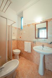a bathroom with a sink and a toilet and a mirror at Taormina Garden Hotel in Taormina +37 photos