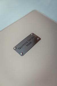 a metal plate on the side of a laptop computer at Taormina Garden Hotel in Taormina