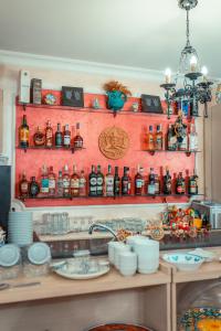 a shelf filled with lots of bottles of alcohol at Taormina Garden Hotel in Taormina