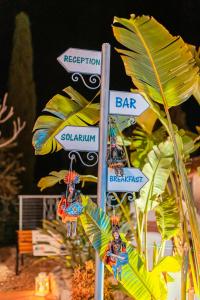 a street sign with a bunch of street signs at Taormina Garden Hotel in Taormina