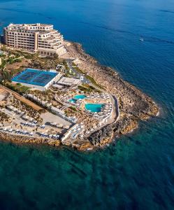 a beach with a large body of water at Radisson Blu Resort, Malta St. Julian's in St Julian's