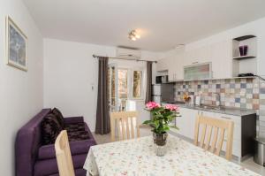 
a kitchen filled with furniture and a table at Apartments Aurelia in Dubrovnik
