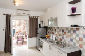 a kitchen with a sink and a counter top at Apartments Aurelia in Dubrovnik