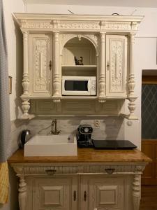 a kitchen counter with a sink and a microwave at Penzio Ostrava in Ostrava