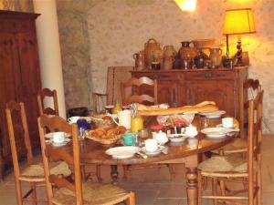 a dining room table with food and dishes on it at La Tonnelle de Vouvray in Vouvray +30 photos