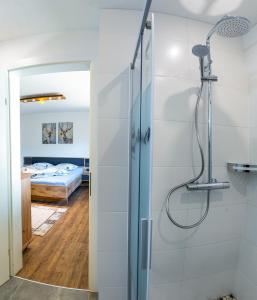 a bathroom with a shower and a bedroom at Appartements Bergwelt in Oetz
