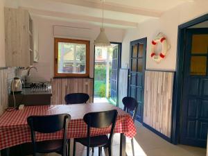 a kitchen with a table and chairs in a kitchen at Letnisko Dębki in Dębki